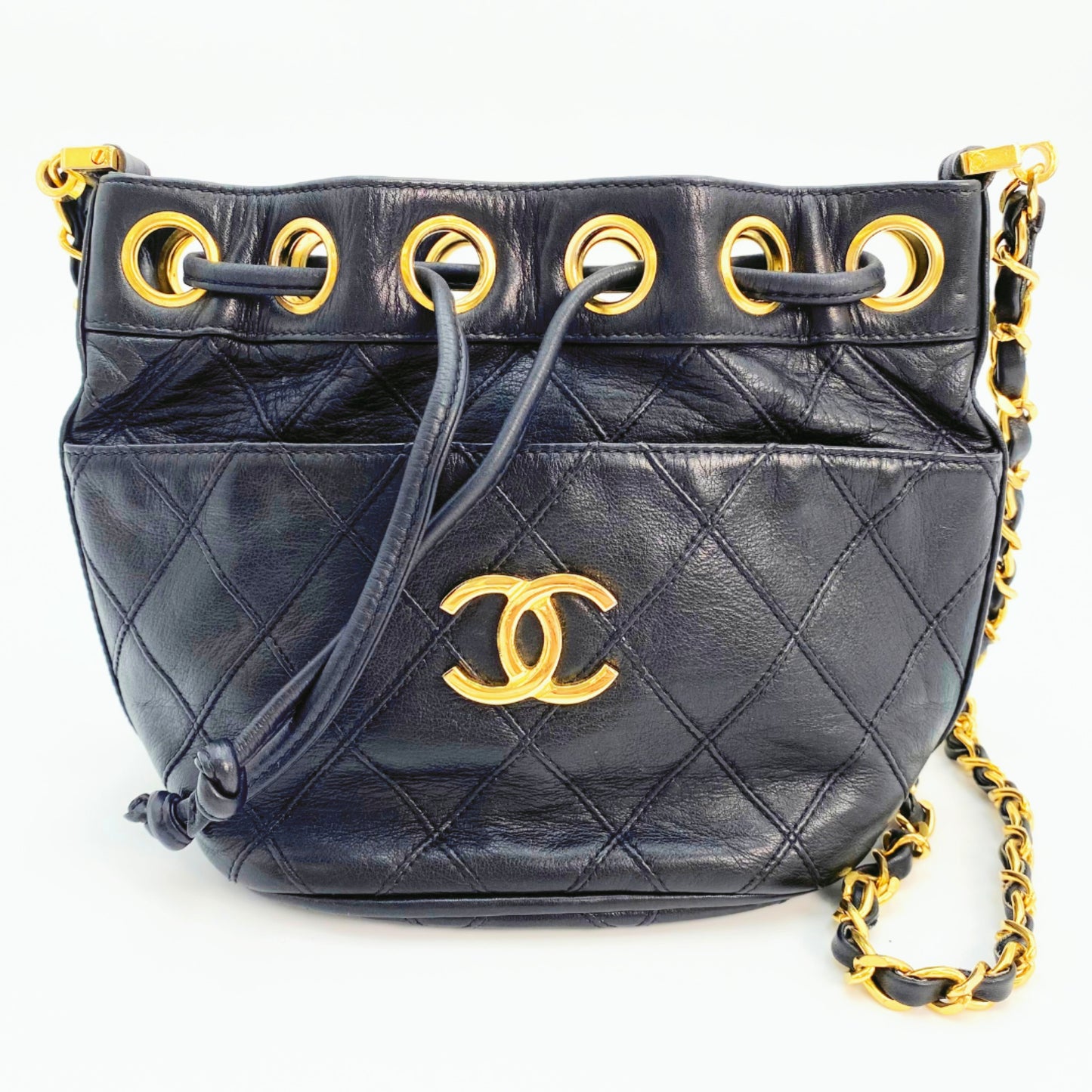 Rylie, Vintage Authentic Chanel 0 series drawstring mini black lambskin with seal