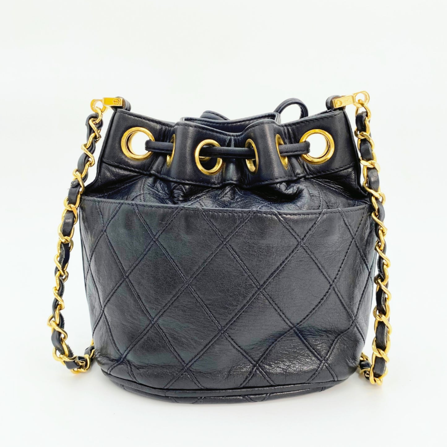 Rylie, Vintage Authentic Chanel 0 series drawstring mini black lambskin with seal