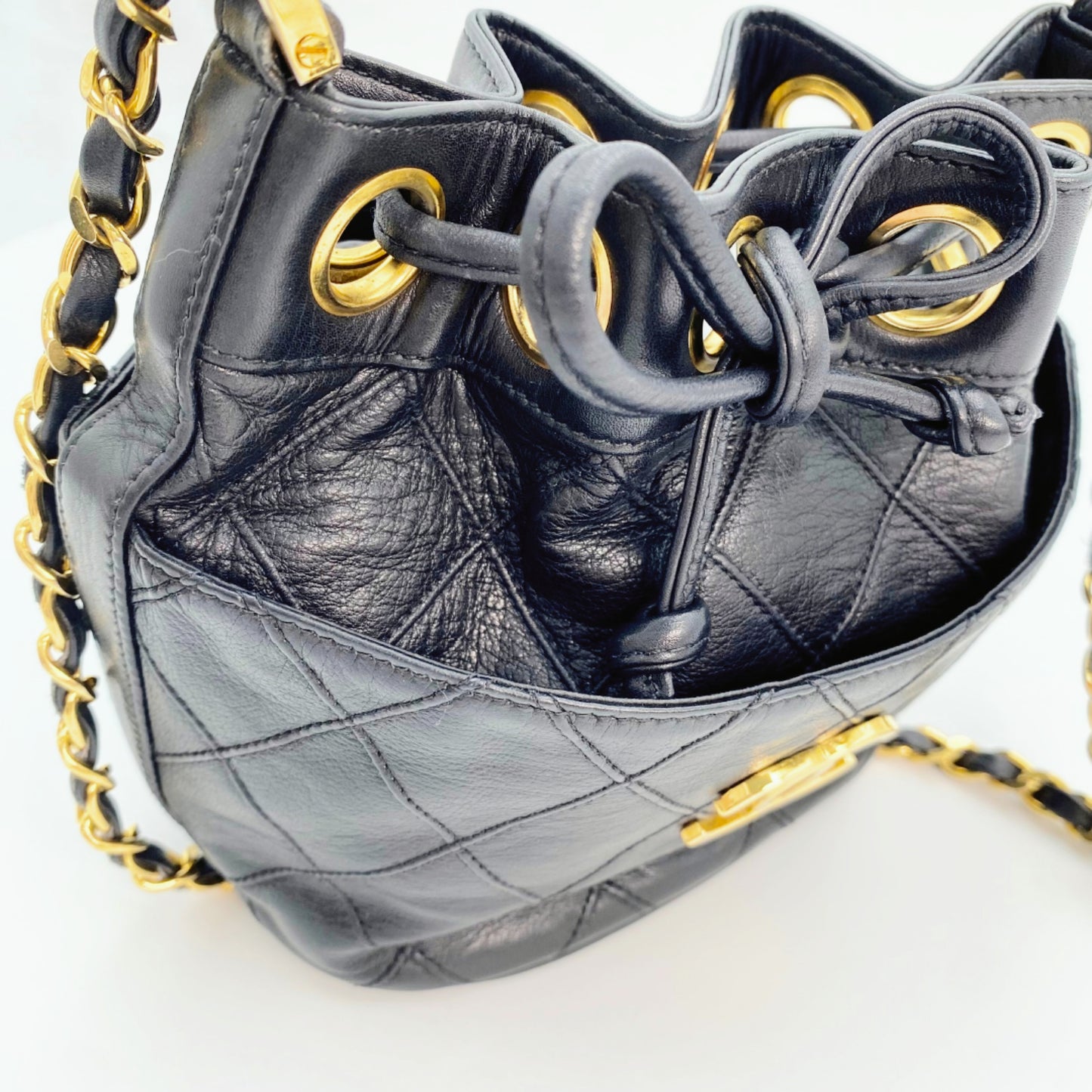 Rylie, Vintage Authentic Chanel 0 series drawstring mini black lambskin with seal