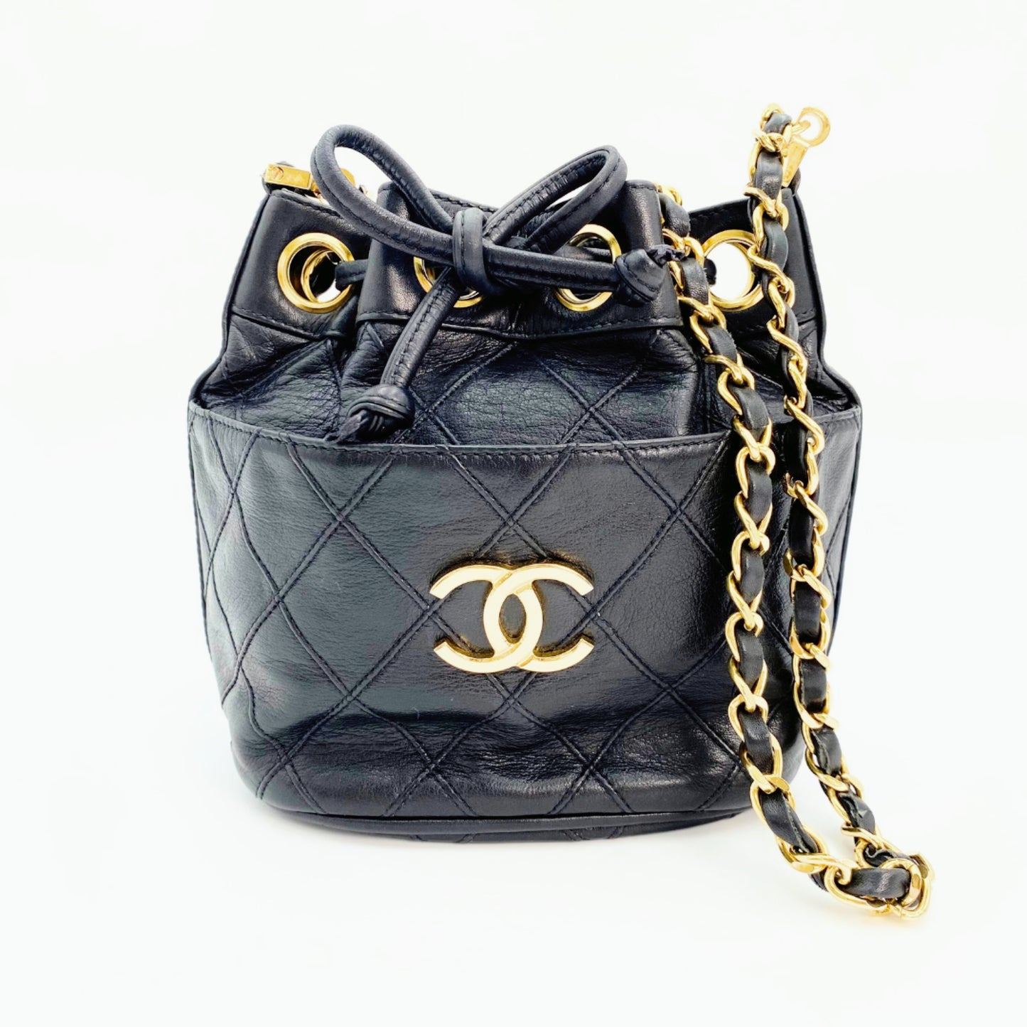 Rylie, Vintage Authentic Chanel 0 series drawstring mini black lambskin with seal