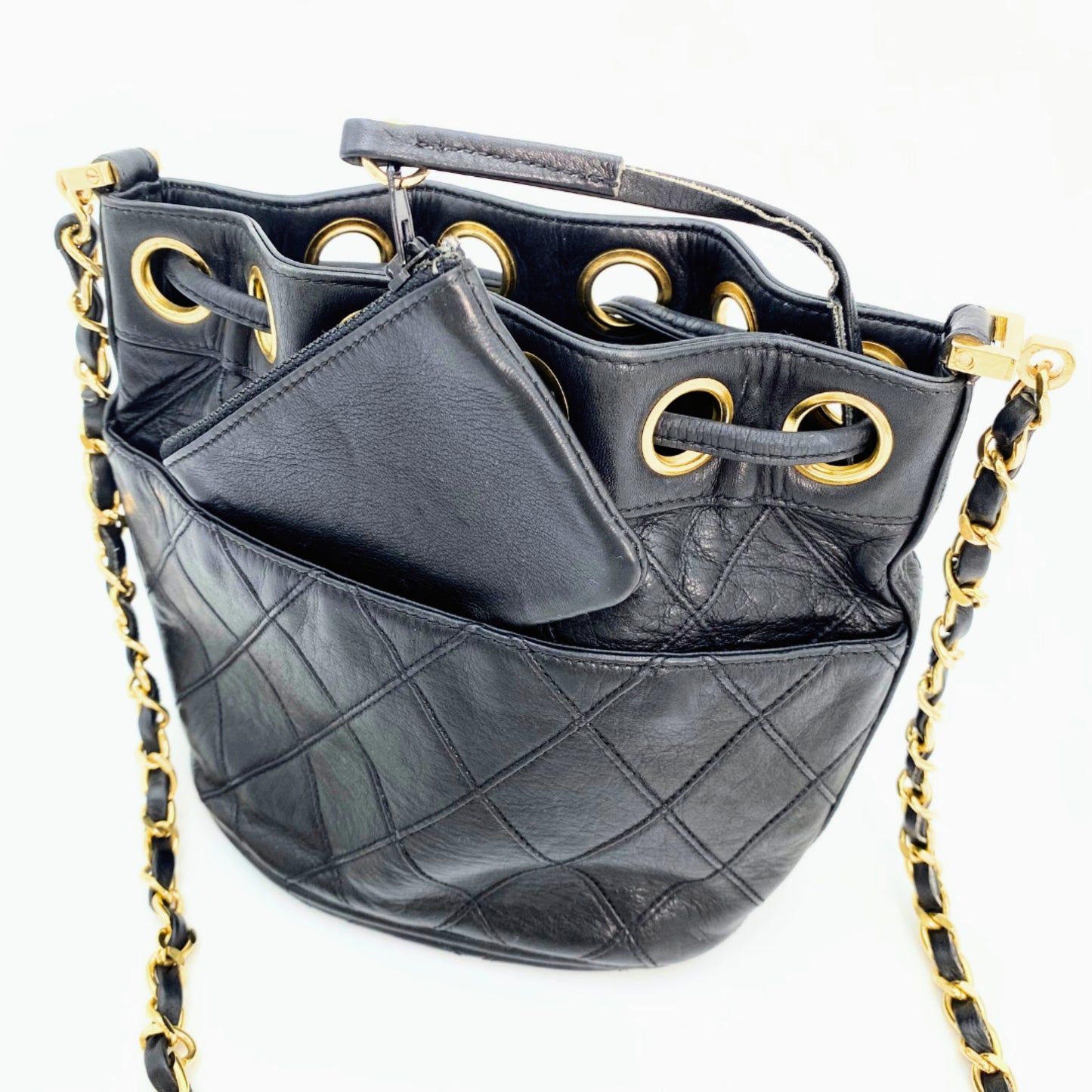 Rylie, Vintage Authentic Chanel 0 series drawstring mini black lambskin with seal