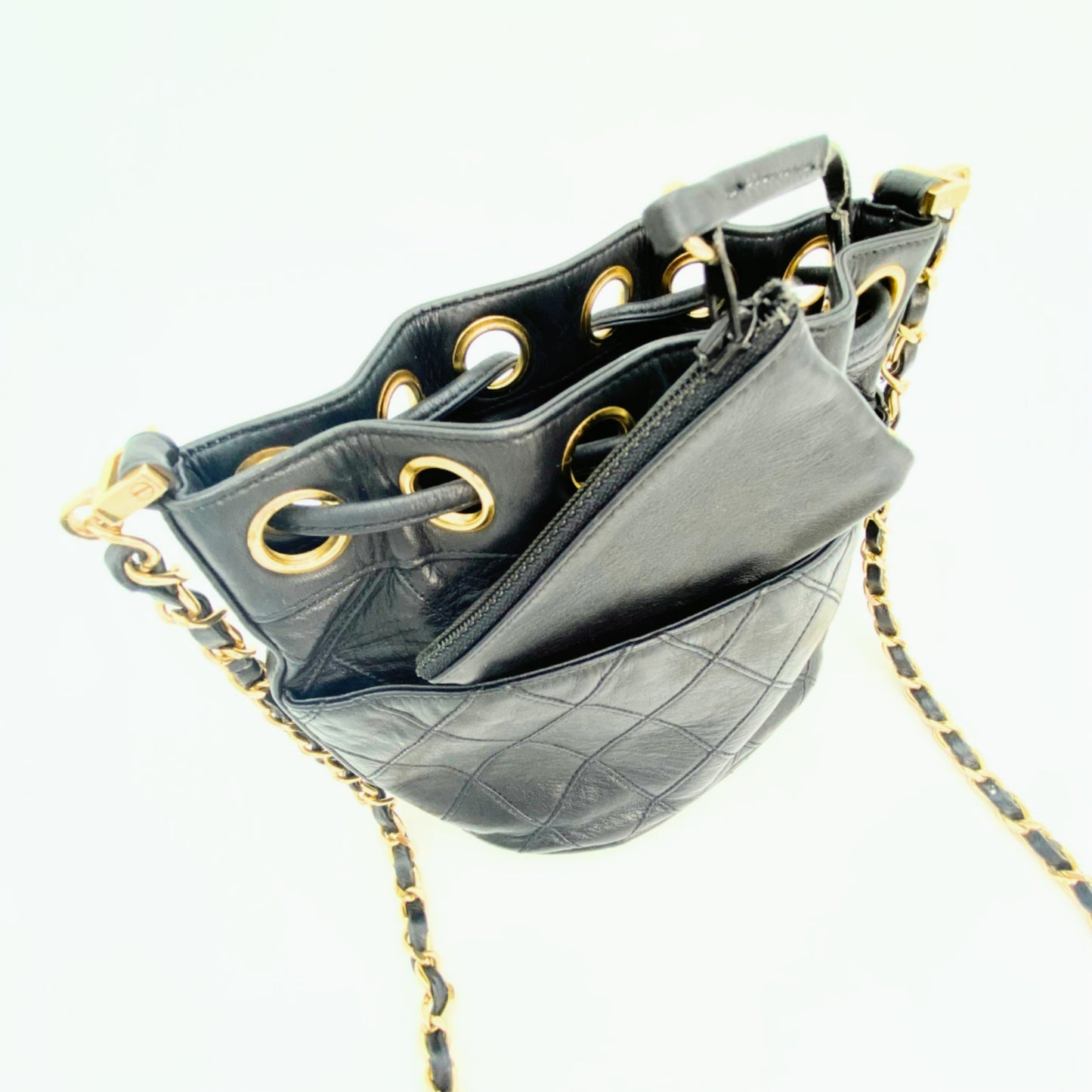 Rylie, Vintage Authentic Chanel 0 series drawstring mini black lambskin with seal