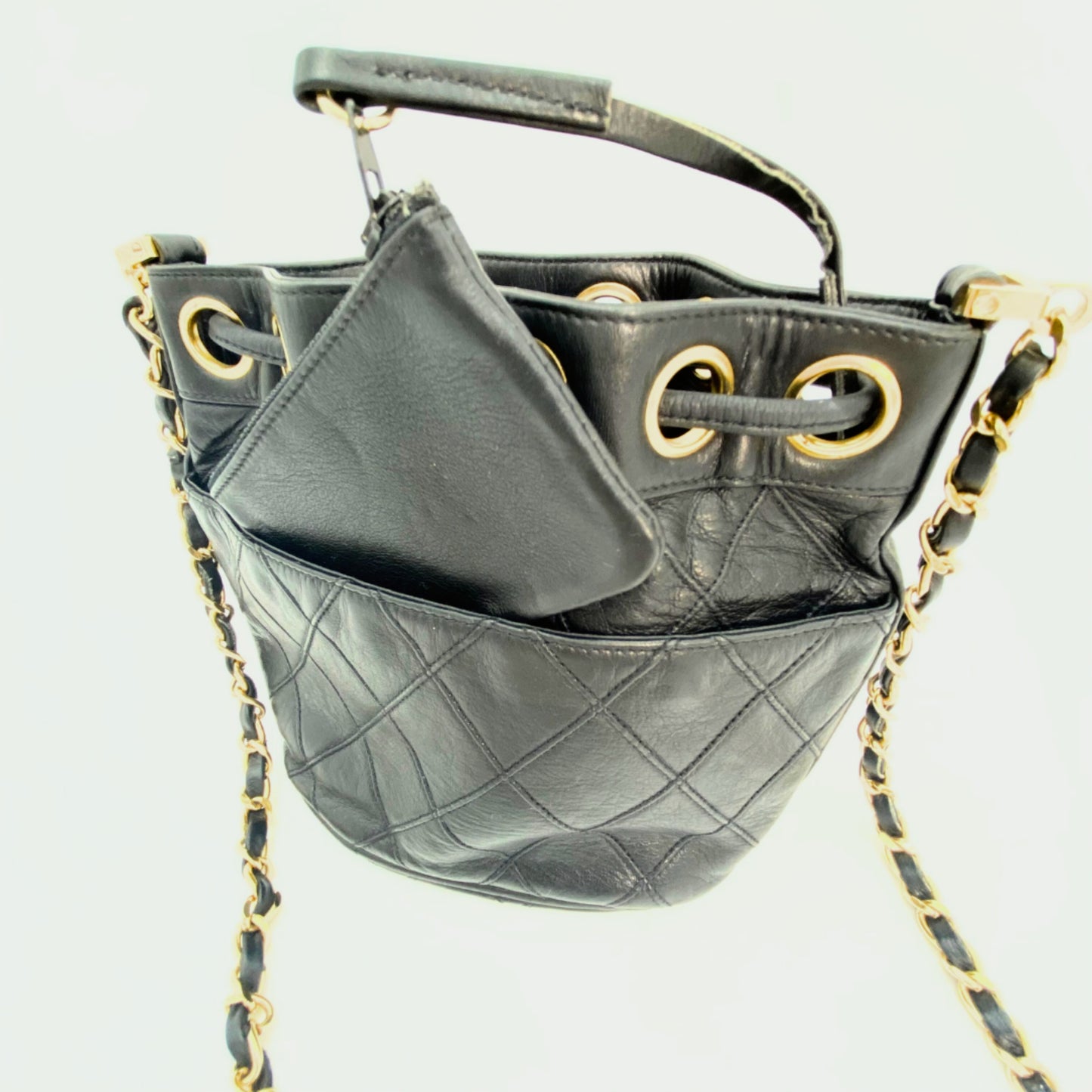 Rylie, Vintage Authentic Chanel 0 series drawstring mini black lambskin with seal