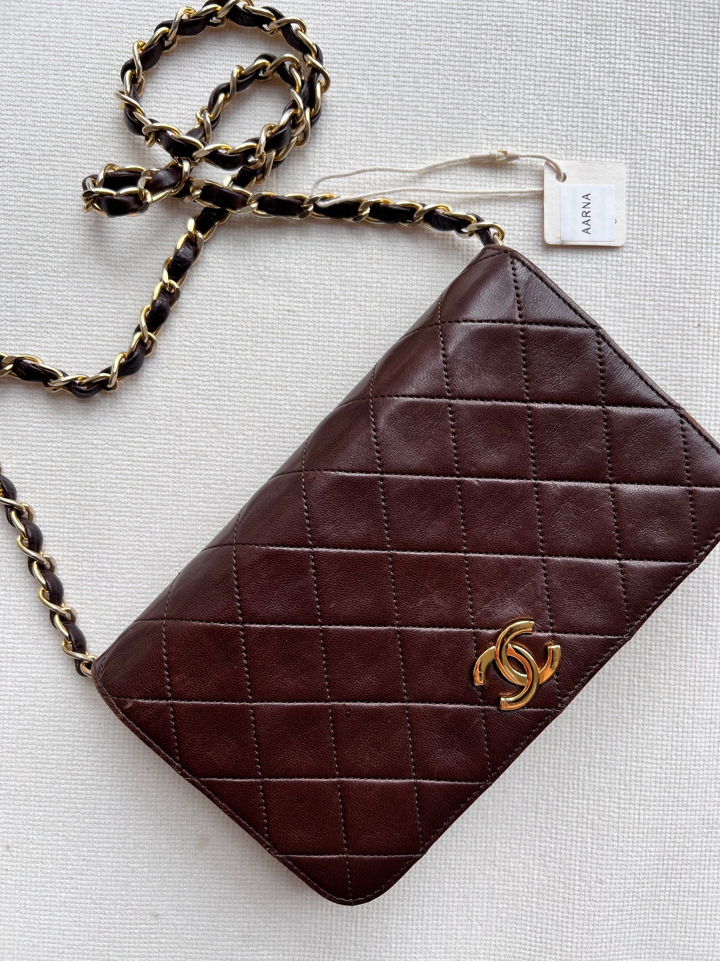 Aarna, Vintage Chanel 1 series brown lambskin clutch on chain with seal only