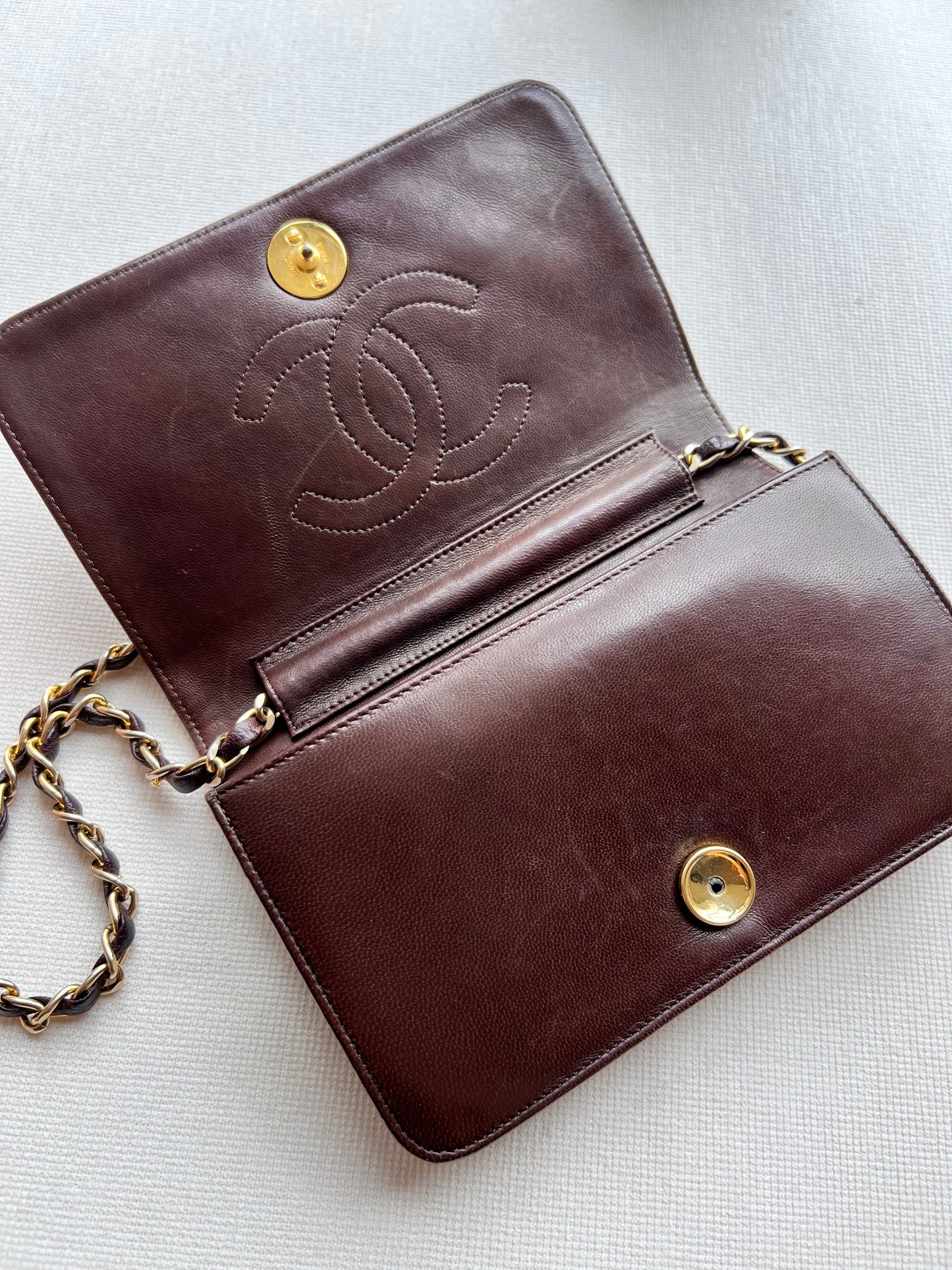 Aarna, Vintage Chanel 1 series brown lambskin clutch on chain with seal only