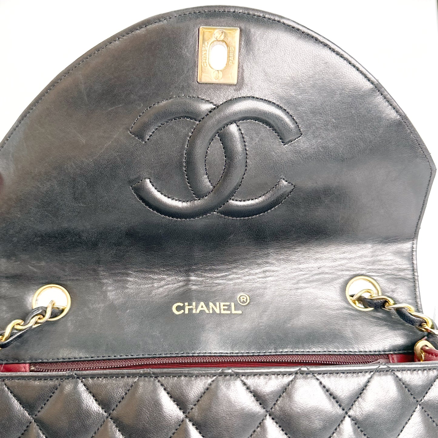 Sylvia, Vintage Authentic Chanel 0 series half moon chain black lambskin with seal