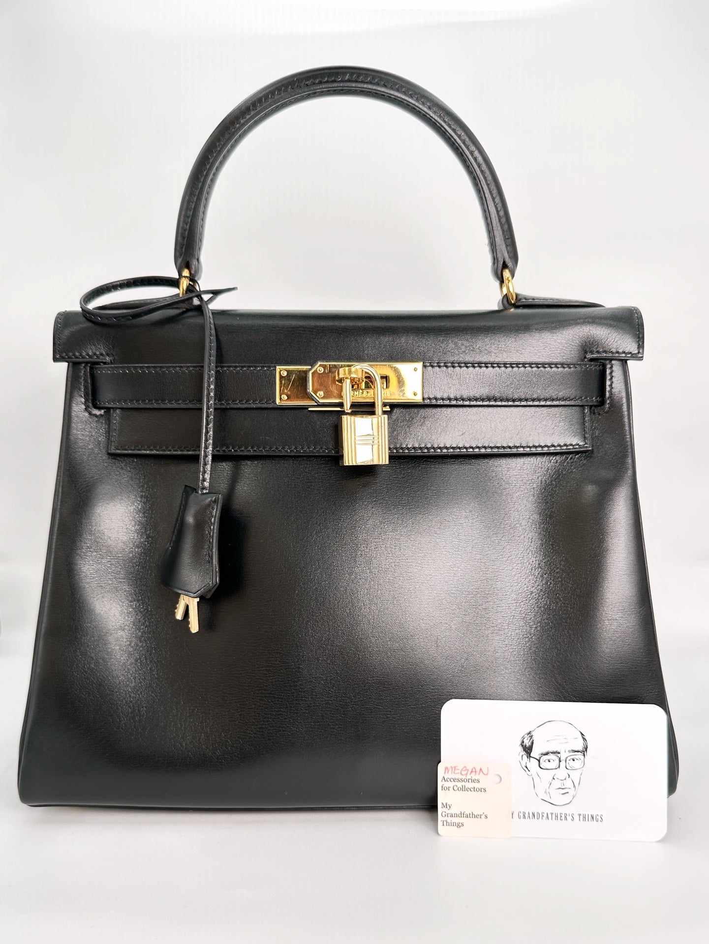 Megan, Vintage Authentic Hermes 🟥C 1999 kelly 28 black box retourne stitching with strap, key, and clochette