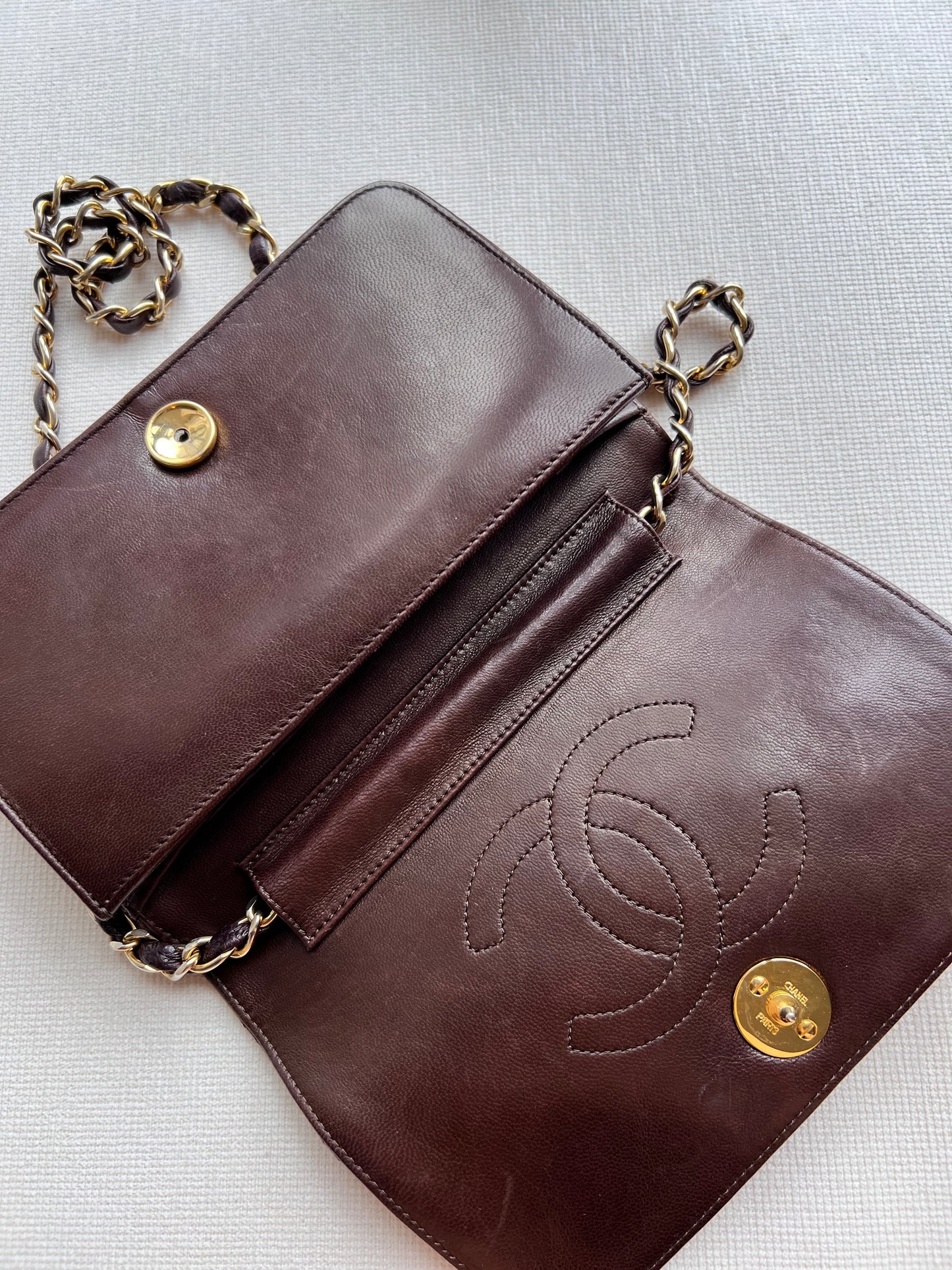 Aarna, Vintage Chanel 1 series brown lambskin clutch on chain with seal only