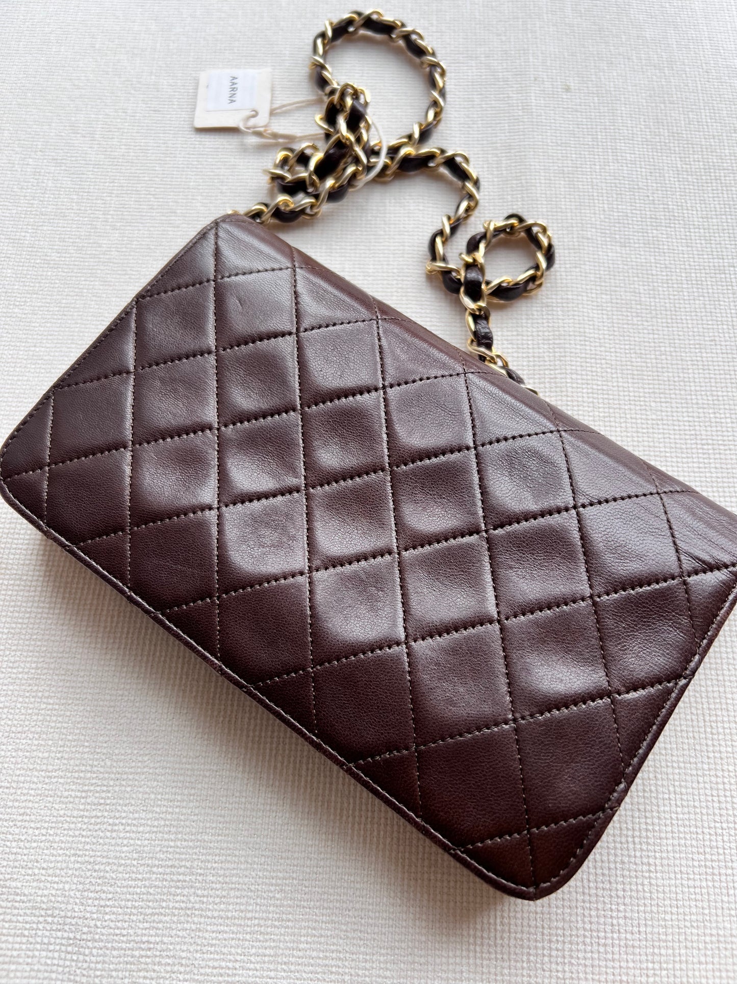 Aarna, Vintage Chanel 1 series brown lambskin clutch on chain with seal only