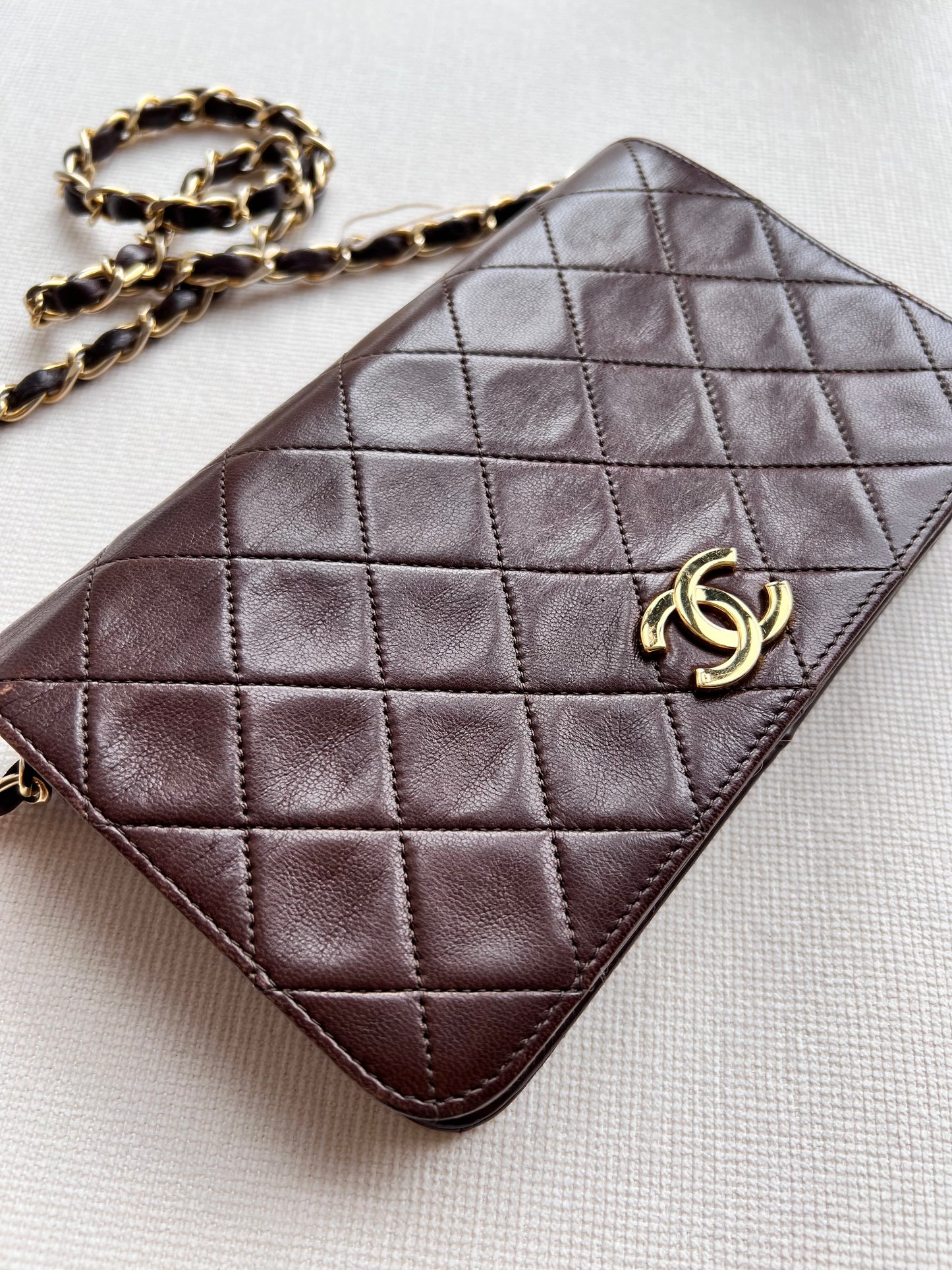 Aarna, Vintage Chanel 1 series brown lambskin clutch on chain with seal only