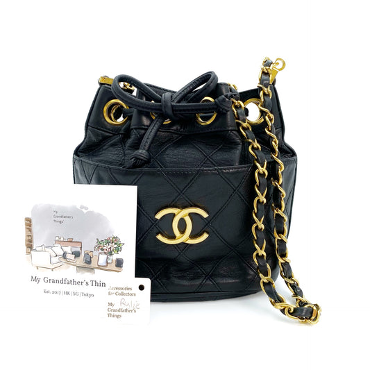 Rylie, Vintage Authentic Chanel 0 series drawstring mini black lambskin with seal