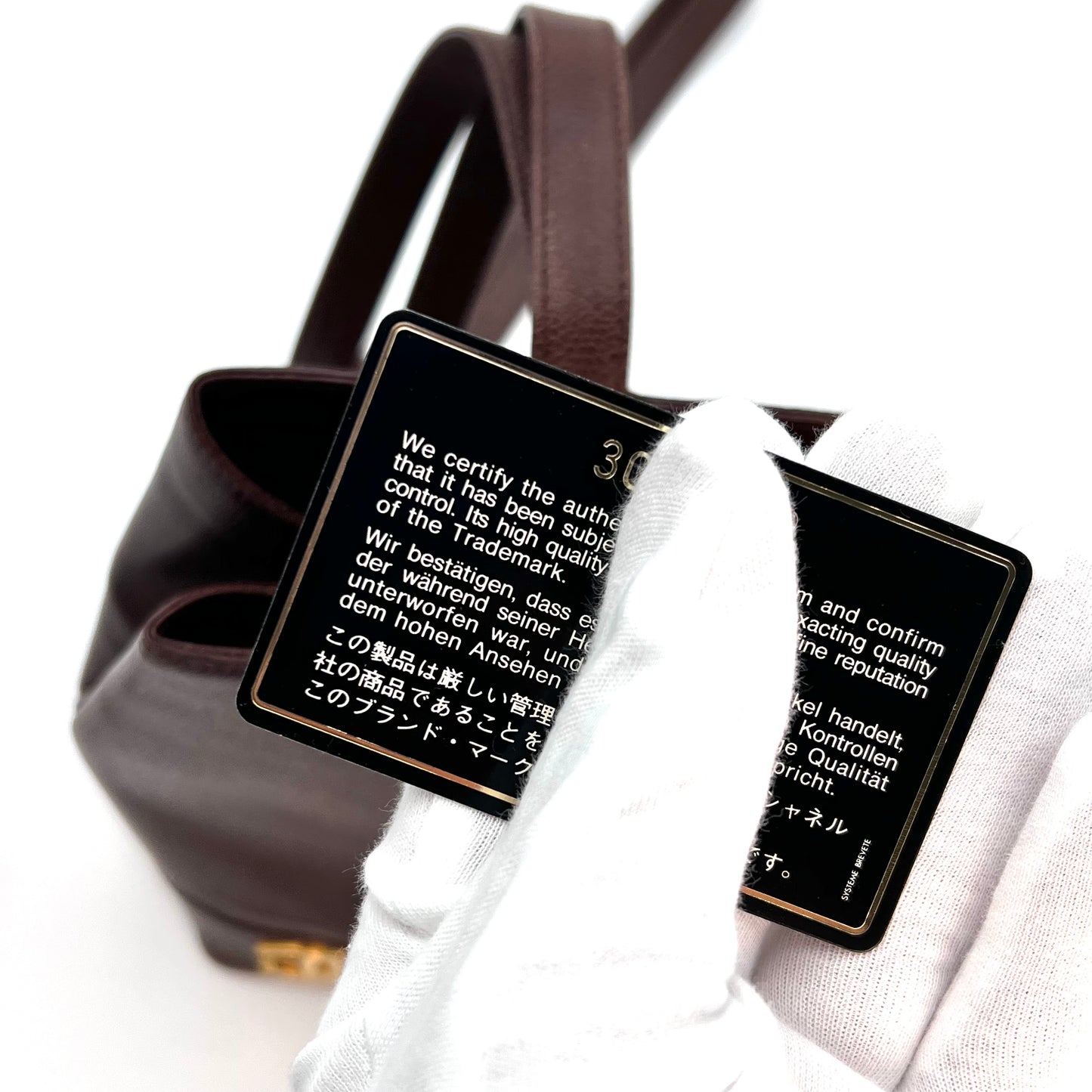 Tripp, 3 Series Brown caviar bucket bag with seal and card