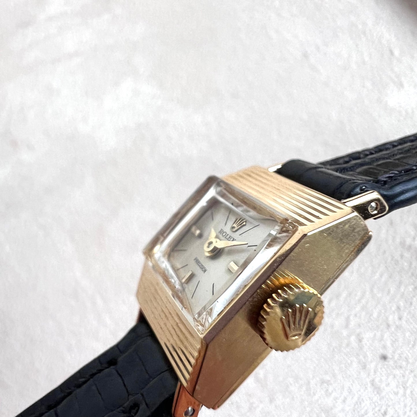 Rolex Precision 18k, step cut case w/ black strap